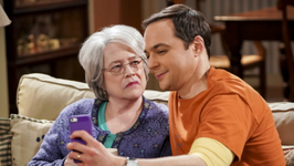 Shaldon and his Grandma sits on a couch. Shaldon shows her somethinh on a phone